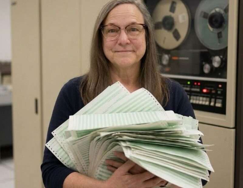 Clare holding old computer printouts